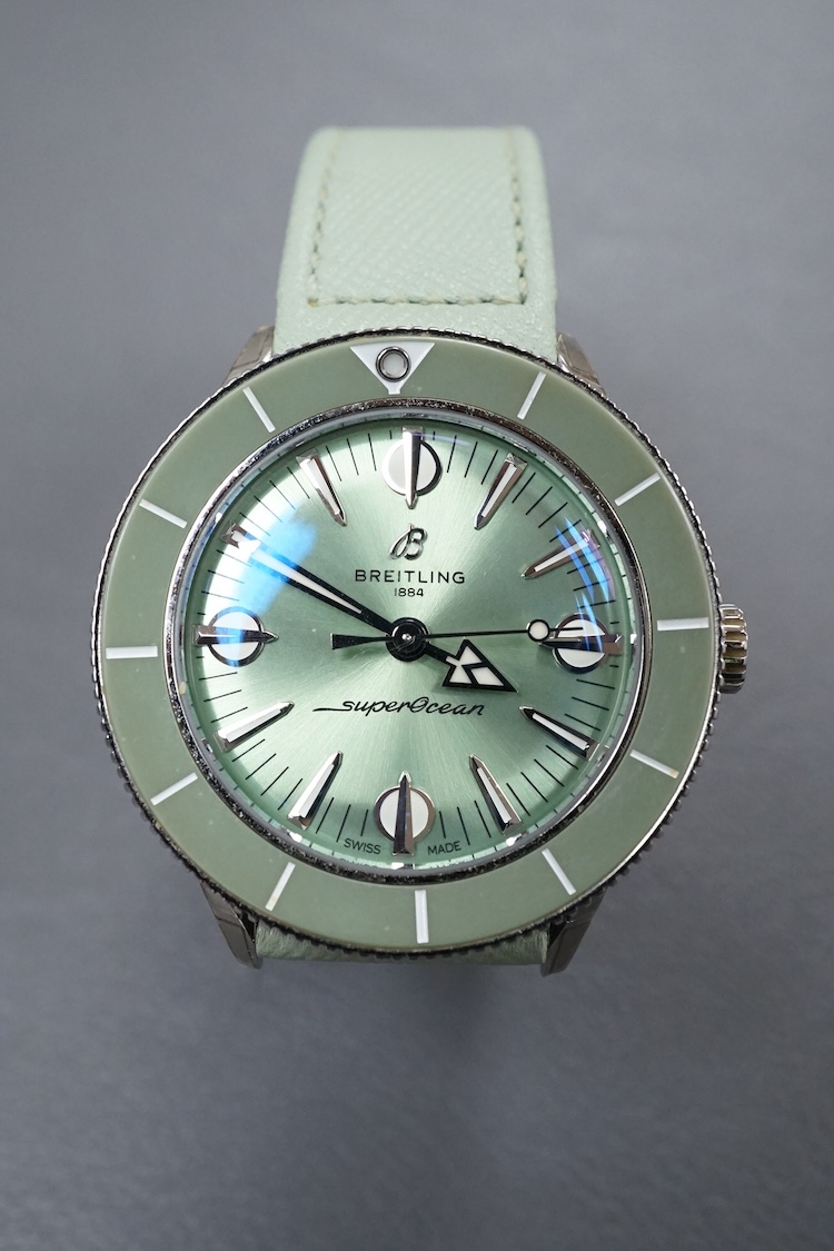 A lady's recent stainless steel Breitling SuperOcean Heritage Automatic cal. 38 57 chronometer wrist watch, with light green dial and baton numerals, case diameter 37mm, on a light green leather strap with Breitling buck